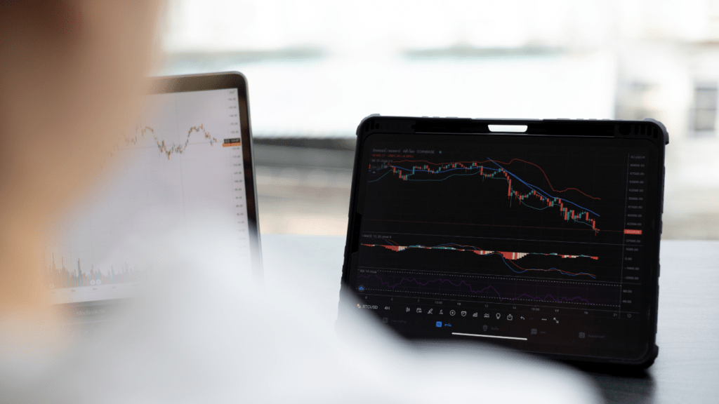 a person is looking at the stock market on their laptop