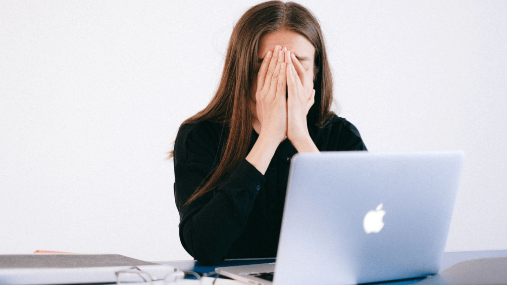 a person covering their face with their hands