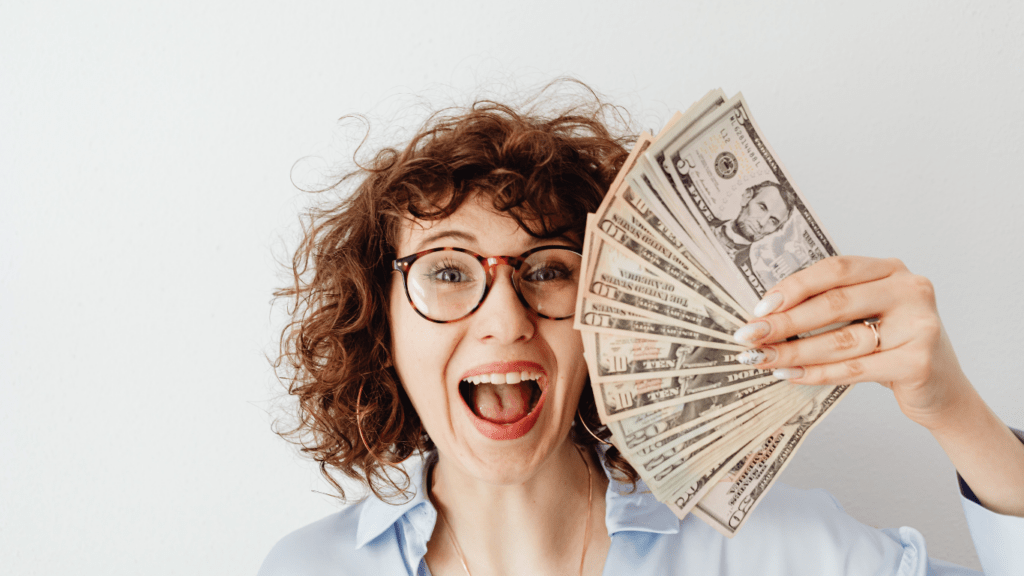 a person holding a bunch of money