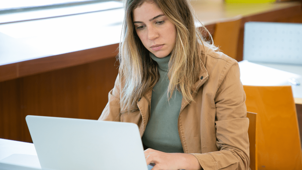 a person sitting in front of a laptop computer