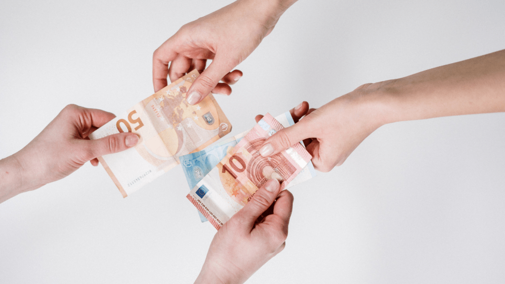 a group of hands holding money