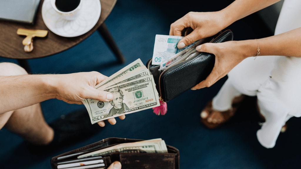 a group of hands holding money