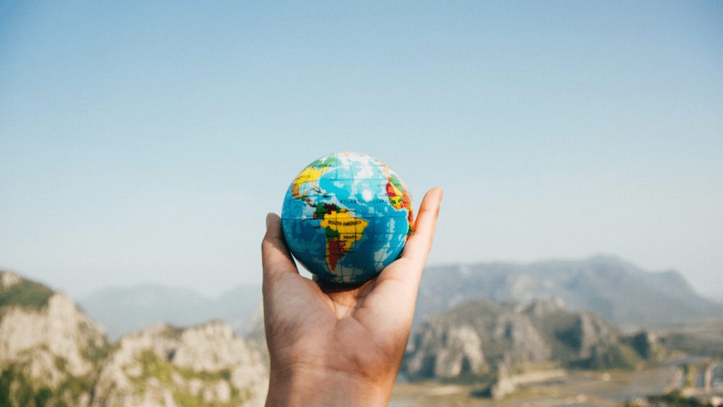 a person holding a globe in their hands