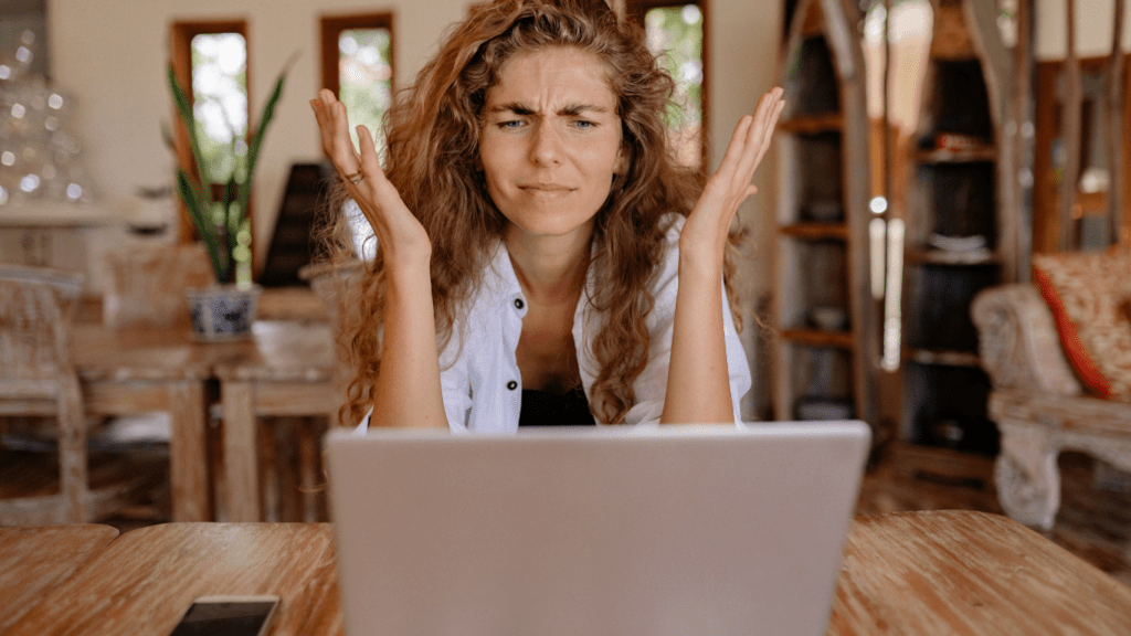 a person sitting in front of a laptop computer